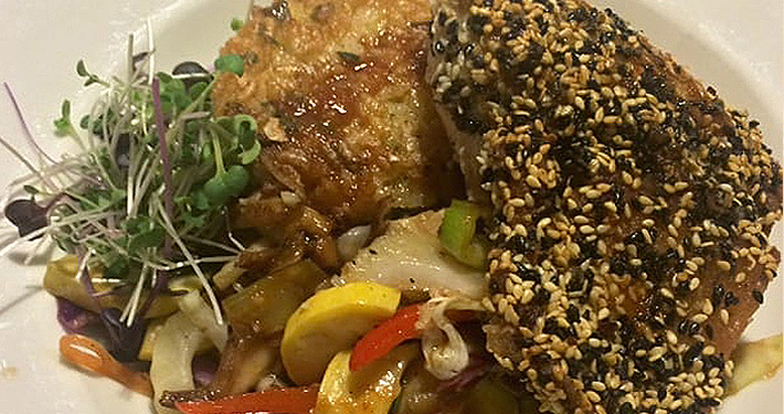 A sesame-crusted fish fillet with peppers, sprouts and a light broth.